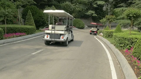 Golf Carts Driving Down A Road Stock Footage 92192833