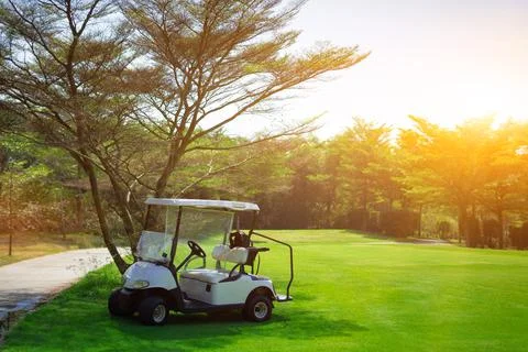 Golf carts line up in the golf course in the morning. Stock Photos