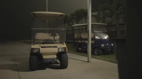 Golf Carts Parked in Heavy Rain at Night Stock Footage 114019017