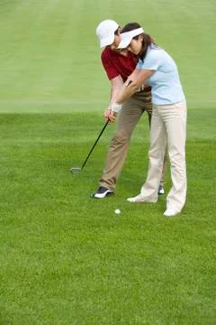 Golf coach teaching playing golf Stock Photos