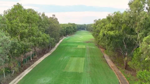 Golf course aerial view with tree-lined fairways and serene sunset Stock Footage 302279766
