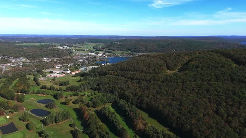 Golf Course and Dense Forest Bordering a Scenic Town Vídeos de archivo 348691933