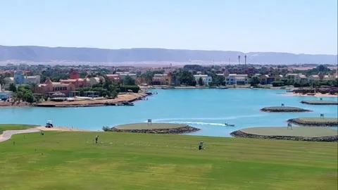 Golf course with aqua lagoon green islands and mountains in El Gouna Egypt. Stock Footage 340106824
