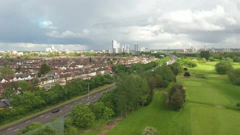 Golf course at busy multilane highway heading to city Stock-Footage 156709712
