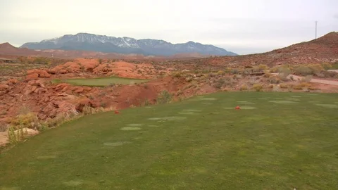 Golf course in desert with sand rocks and mountains A Video stock 125344092