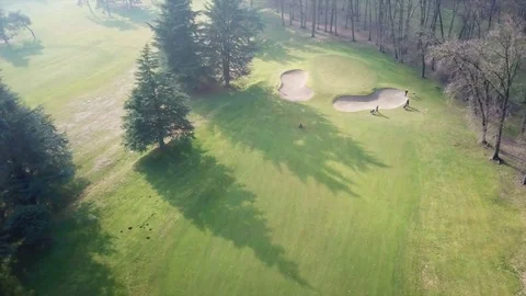 Golf course drone aerial view with players near the hole Stock-Footage 85384997