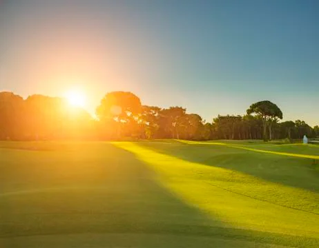 Golf course during sunrise Stock Photos