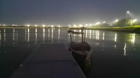 Golf course flood lights over the water Stock Footage 193994073