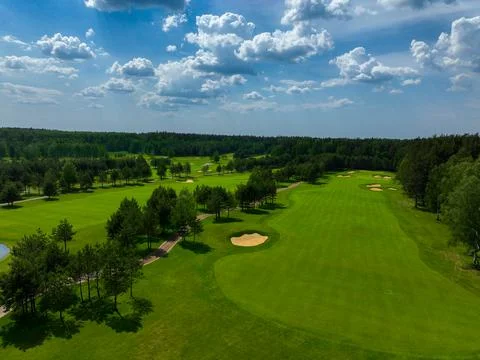Golf course with green fields and forest Stock Photos