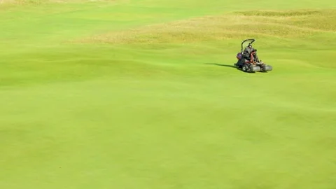 Golf Course Greenkeeper Mowing Putting Green in St Andrews Stock Footage 314408852