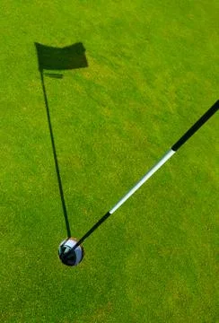 Golf Course Hole With Flagstick Shadow Foto stock