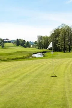 Golf course. Hole with a white flag on a sunny day Stock-Fotos