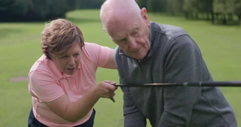 Golf course, instructor teaching man and club at field, nature or outdoor for Stock Footage 335914550