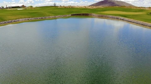 Golf Course Low Angle Aerial Over Pond Stock Footage 112896625