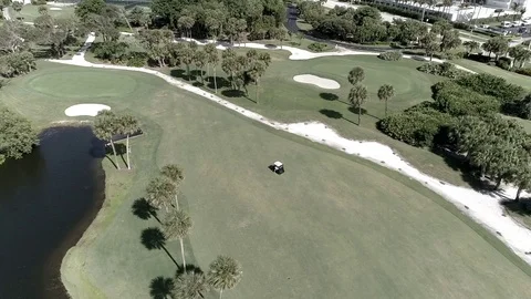 Golf Course with moiving golf cart in shot Stock Footage 103284435