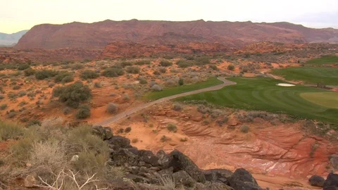 Golf course putting green sits inside red desert rocks and sand A Stock Footage 125344216