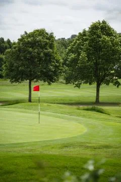 Golf course with red flag Stock Photos