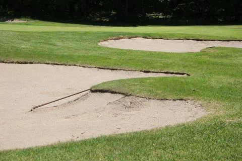 Golf Course Sand Bunkers with Rake on Sunny Day Stock Photos