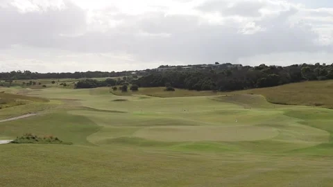 Golf course scenery moonah trees grass tee greens blue sky Stock Footage 228408281
