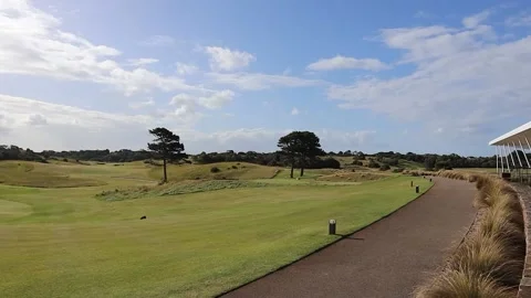 Golf course scenery moonah trees grass tee greens blue sky Stock Footage 228408506
