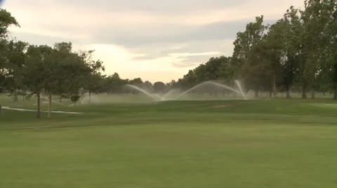 GOLF COURSE SPRINKLERS IN TIME LAPSE TIMELAPSE ON BEAUTIFUL MORNING HD 1080 Stock Footage 23948952