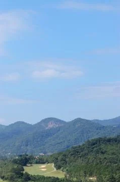 Golf course surrounded by forest Stock Photos