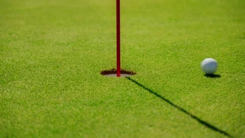 Golf cup and red flagstick on putting green in Montenegro, Adriatic Stockbeeldmateriaal 329413087