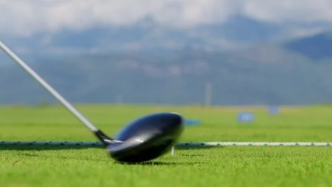 Golf driver lines up a teed ball, practice range, Montenegro Vidéo 329413192