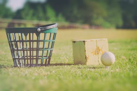 Golf at the driving range Basket with golf balls at the rough zone of course Stock Photos
