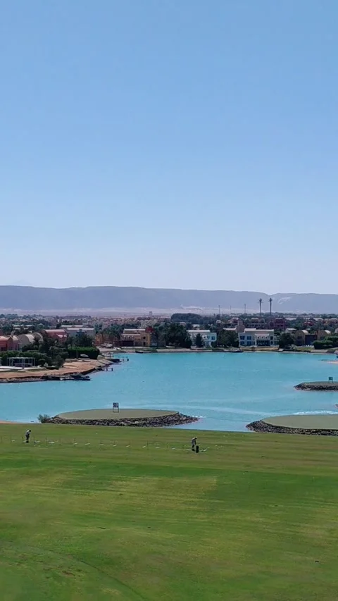 Golf driving range green fairway with aqua lagoon view in El Gouna Egypt. Stock Footage 340106700