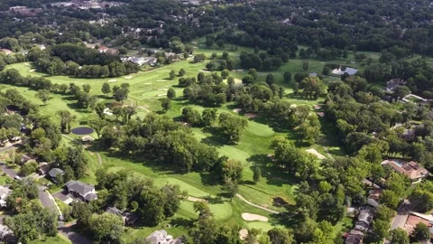 Golf Fairway Bordering Mature Trees and Suburban Homes From Above Stock Footage 344710375