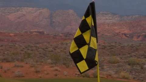 Golf flag in front of desert mountains C Video stock 125344203
