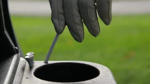 Golf glove hand taking tee and replacing 스톡 동영상 153698422