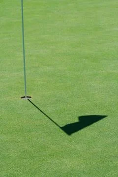 Golf green flag shadow Stock Photos