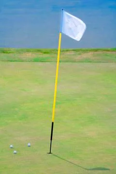 Golf hole with a flag Stock Photos