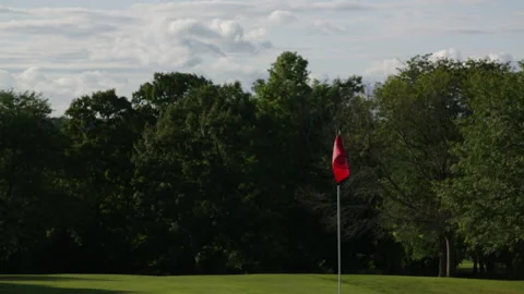 Golf hole flagging flying in the wind 스톡 동영상 153698619