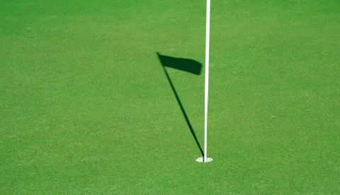 Golf hole with the shadow of the flag Stock-Fotos