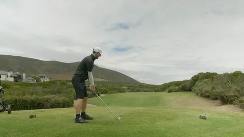 Golf man hitting driver off tee box at course Video stock 129379251
