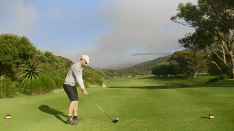 Golf man hitting driver off tee box at course Stock Footage 129381559