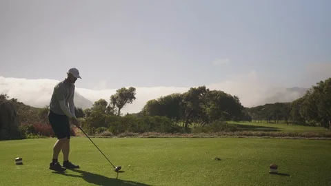Golf man hitting driver off tee box at course Video stock 129381733