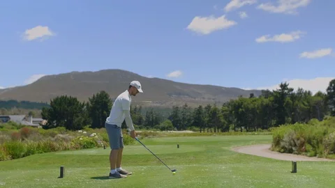 Golf man hitting driver off tee box at course Video stock 129382813