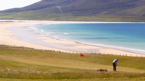 A golf player in a Golf Course by the sea. Two shots. Stock Footage 97520247