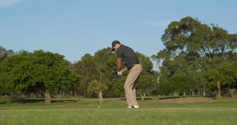 Golf player hitting the ball with his club Stock Footage 129857233