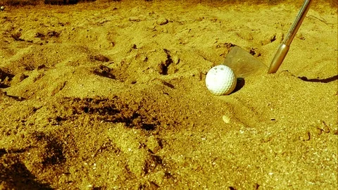 Golf player hitting the ball in the sand, slowed down Stock Footage 77863548