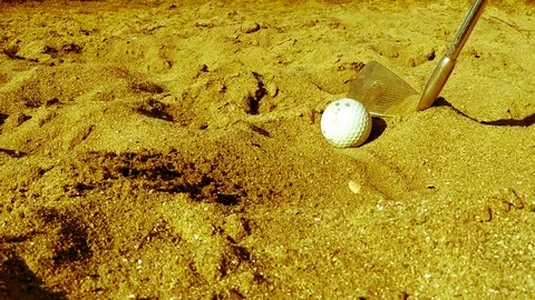 Golf player hitting the ball in the sand Stock Footage 77863564