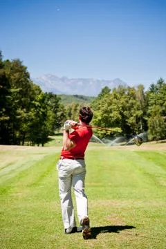 Golf player performs a tee shot Stock Photos