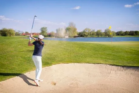 Golf player pitching from bunker. Stock Photos