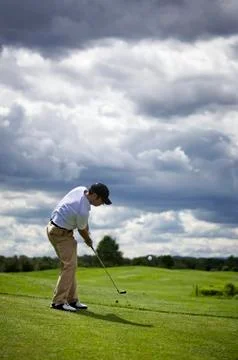 Golf player pitching. Stock Photos