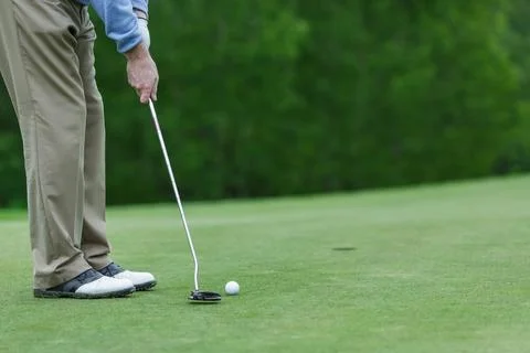 Golf Player Putting Ball on Green Field Closeup Outdoor Sports Action Train.. Stock Photos