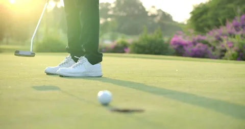 Golf player putting a golf ball into hole. Video stock 149736349